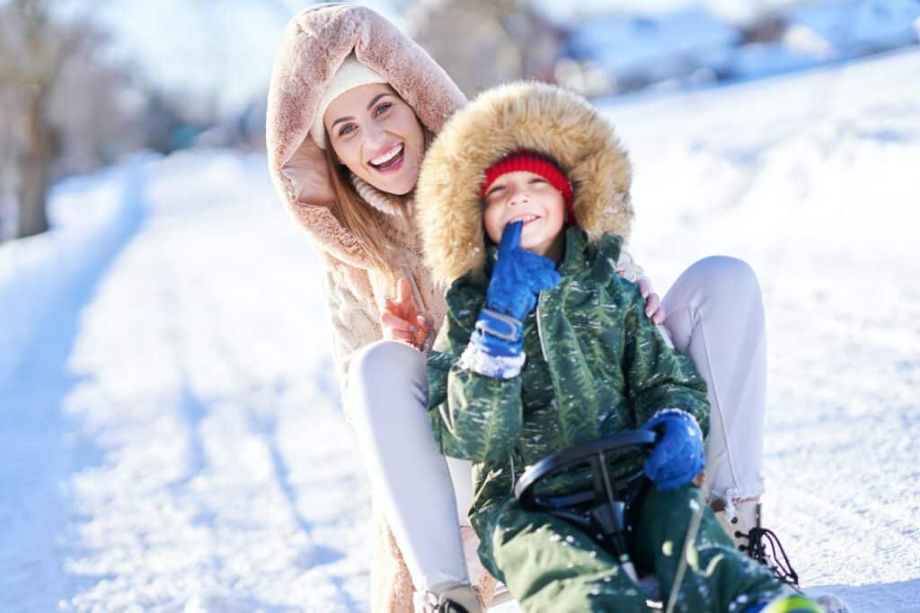 Nice happy family having fun on winter snow