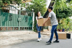 Couple carrying heavy box